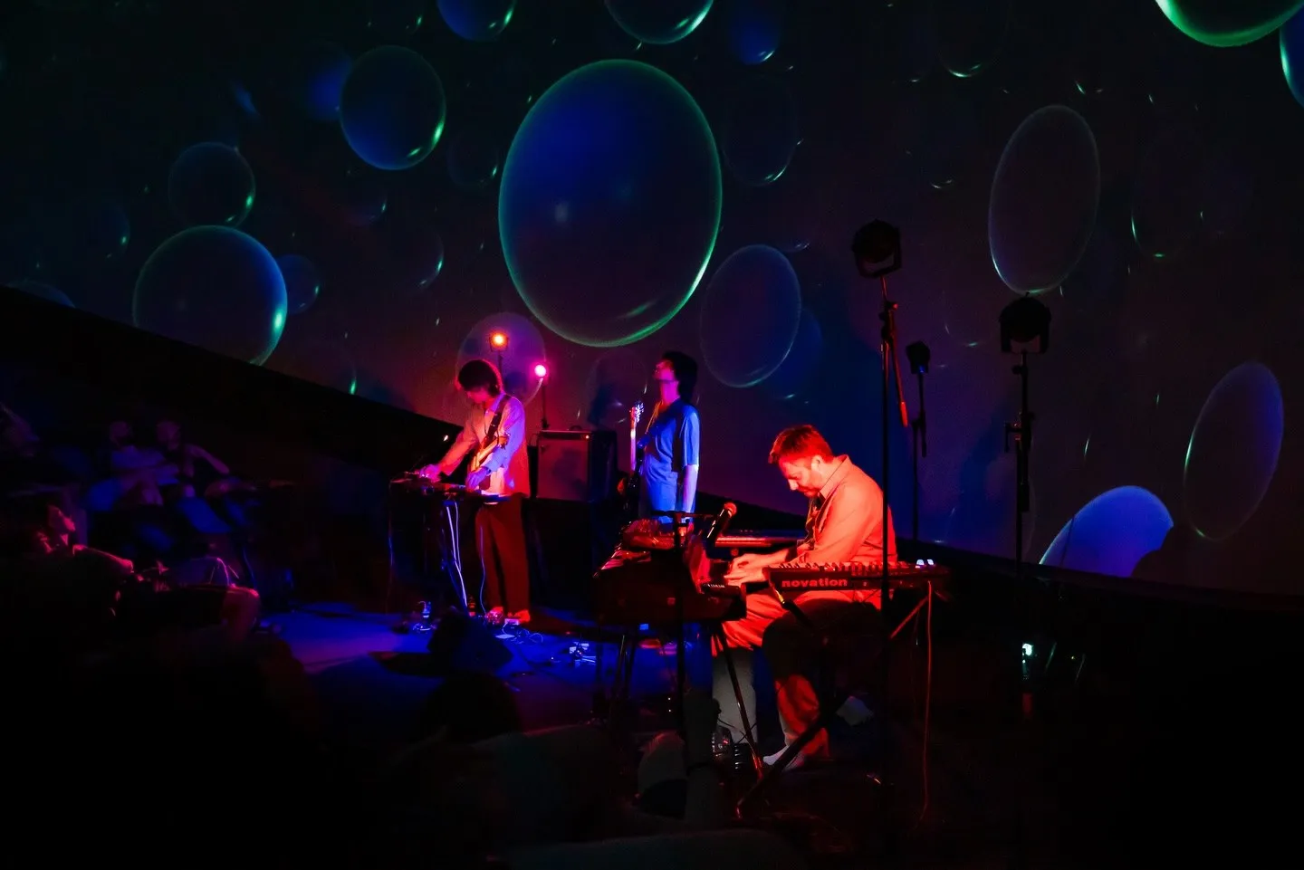 Greg Foat and the trio under the visuals